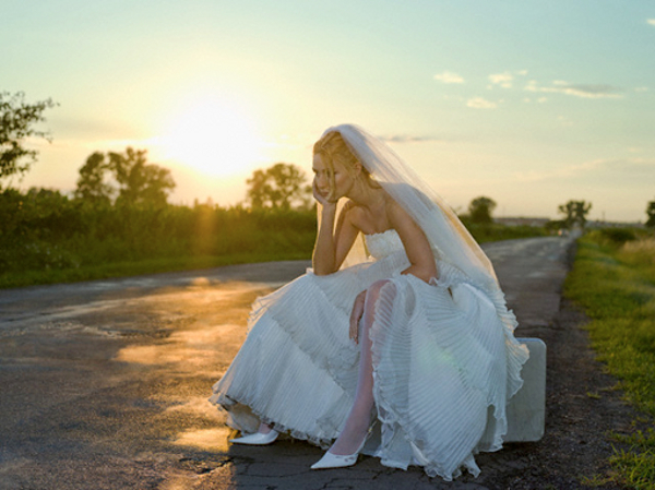 Bride Sitting on Side of Road --- Image by © Roy Botterell/zefa/Corbis